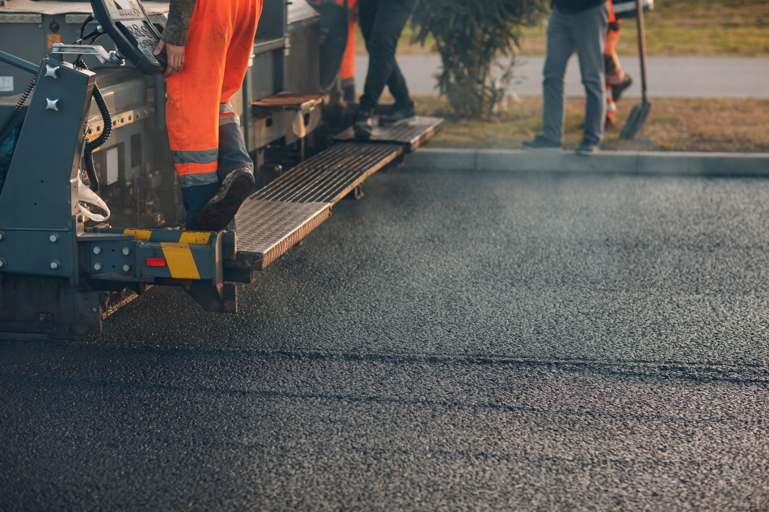 Asphalt paving. Paver machine and road roller. New road construction.